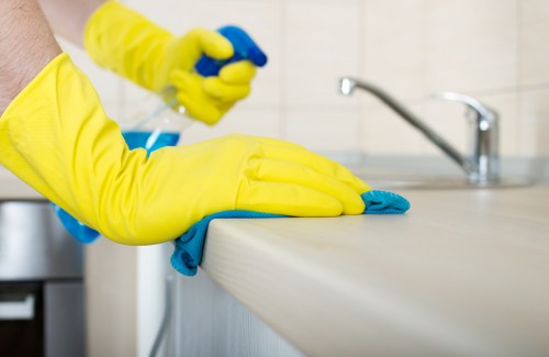 Professional cleaners maintaining desks and shared spaces in an Acton office