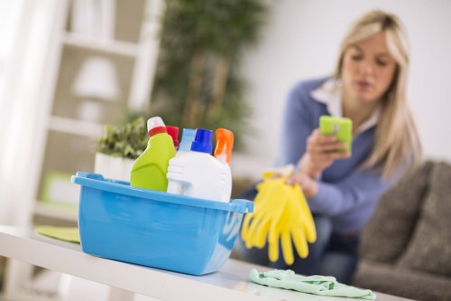 Cleaner wearing PPE while maintaining a safe and tidy workspace